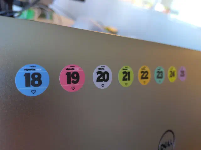 Vignettes Tech collées au dos de l’écran de mon PC portable, montrant que je l’utilise depuis 2018
